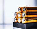 AI generated illustration of An organized stack of batteries on a white background.