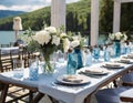 an outdoor table is set with place settings and white flowers Royalty Free Stock Photo