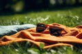 AI generated illustration of a pair of dark-tinted sunglasses laying on a bright yellow blanket Royalty Free Stock Photo