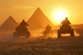 People in desert buggies with pyramids