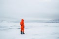 AI-generated illustration of a person in an orange snowsuit on snowy terrain