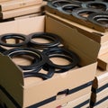 AI generated illustration of a pile of cardboard boxes stacked on a wooden surface with black rings