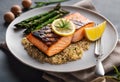 a plate with rice and salmon with asparagus and lemon on top Royalty Free Stock Photo