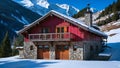 red and gray house on a snow covered slope with mountains in the background Royalty Free Stock Photo