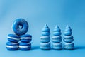AI generated illustration of rows of stacked blue doughnuts on a blue background