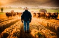 A rugged cowboy standing overlooking a herd of cattle grazing in a lush grassy field