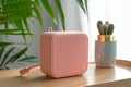 AI generated illustration of a sleek and portable bluetooth speaker in a delightful shade of pink