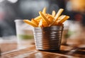 AI generated illustration of a small bowl of tasty French fries on a restaurant table