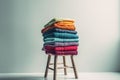 AI-generated illustration of a stack of neatly folded colorful towels on a stool.