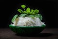 AI generated illustration of steaming noodles, topped with greens