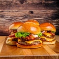 AI generated illustration of Three bacon cheeseburgers with lettuce on wooden board Royalty Free Stock Photo