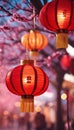 three red lanterns hang from trees and flowers outside at night Royalty Free Stock Photo