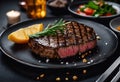 succulent steaks are artfully arranged on black dinner plates, accompanied by orange wedges