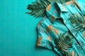 AI generated illustration of a tropical shirt on a vibrant blue background with fern branches