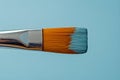 AI generated illustration of a vibrant paintbrush with blue and orange bristles