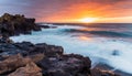 AI generated illustration of vibrant sunset over rocky beach, adorned by gentle breeze Royalty Free Stock Photo