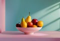 a bowl full of fruit sitting on top of a pink counter Royalty Free Stock Photo