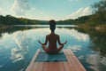 a woman is meditating on a dock by a river