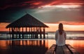 AI generated illustration of a woman on a wooden pier meditating against a stunning sunset Royalty Free Stock Photo