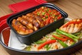 the tray is on a wooden table with rice and vegetables
