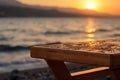 AI-generated illustration of a wooden table surrounded by a picturesque beach at sunset.