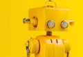 AI generated illustration of a yellow robotic model standing on a desk Royalty Free Stock Photo