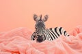 zebra lying in a pink blanket with its eyes closed, Royalty Free Stock Photo