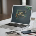 Silver Laptop Displaying Happy New Year Graphic with Decorative Elements - AI-Generated Royalty Free Stock Photo