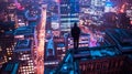 Silhouette of a Person Overlooking a Neon-Lit City at Night. Urban Skyline, Modern Photography, Vibe of Metro Life Royalty Free Stock Photo