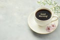 Coffee cup and flower on light grey background with minimalist gold text Good Morning Royalty Free Stock Photo