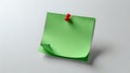 Green note pinned to a white wall, blank space for text Royalty Free Stock Photo