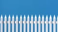 White picket fence on blue background