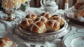 Easter. Good Friday. Hot cross buns on a silver tray on a white tablecloth