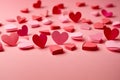 Valentine week Background of a collection of red and pink paper hearts arranged at the bottom of a light pink background.