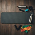 AI-Generated Flat Lay of Exercise Mat and Fitness Accessories on Wooden Background Royalty Free Stock Photo