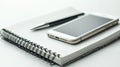 Open Spiral Notebook With Smartphone And Pen On White Background, Technology And Writing Tools Interaction Royalty Free Stock Photo