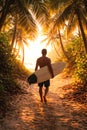 Surfer Walking Through Palm Tree Path Toward Beach At Tropical Sunset Royalty Free Stock Photo