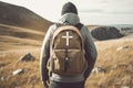 A man with a backpack and a cross on a mountain. Missionary work