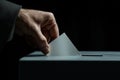 Man putting voting ballot to the voting box. Election concept