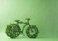 Model of bicycle made of leaves and plants against a green wall. Earth Day and Environmentalism concept Royalty Free Stock Photo