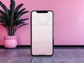 AI-Generated image of A phone is sitting on a table in front of a pink wall