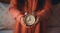 Innocence in Time: A Little Girl\'s Hands Grasping an Analog Alarm Clock