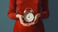 Time Management in Business: Businesswoman\'s Hands Holding an Analog Alarm Clock