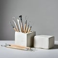 AI-Generated Image of Clay Sculpting Tools with Wooden Handles in a White Box Next to a Block of Clay