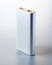 Tall Silver Power Bank Standing on White Surface Royalty Free Stock Photo