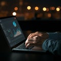 AI-Generated Person Using Laptop at Night with Graphs and Charts on Screen Royalty Free Stock Photo