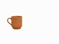 Rustic terracotta mug on a clean white background Royalty Free Stock Photo