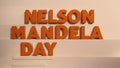 Text design for Nelson Mandela Day in bold orange letters on a light background. The text emphasizes the significance of the Royalty Free Stock Photo