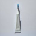 AI-Generated Image: White Tube of Toothpaste with Blue-Striped Toothbrush Royalty Free Stock Photo