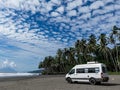 AI-Generated image of A white van is parked on a beach next to palm trees Royalty Free Stock Photo